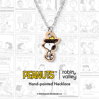 Officially licensed Peanuts Snoopy and Woodstock Nest Necklace showing Snoopy walking with a bird's nest on his head and yellow Woodstock sitting inside, on a silver-coloured chain.