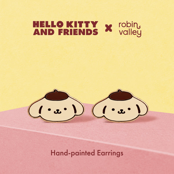 Hand-painted earrings resembling a dog with a hat on a pink and yellow background, featuring Hello Kitty and Friends and Robin Valley logos.