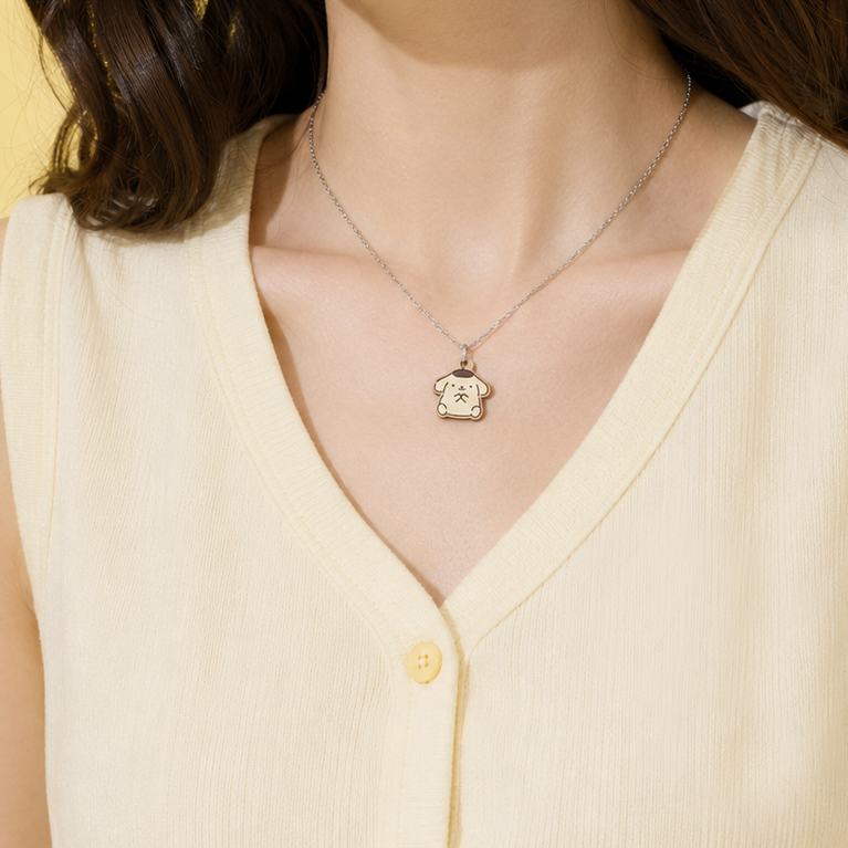 Necklace with a pendant worn by a person in a light yellow top